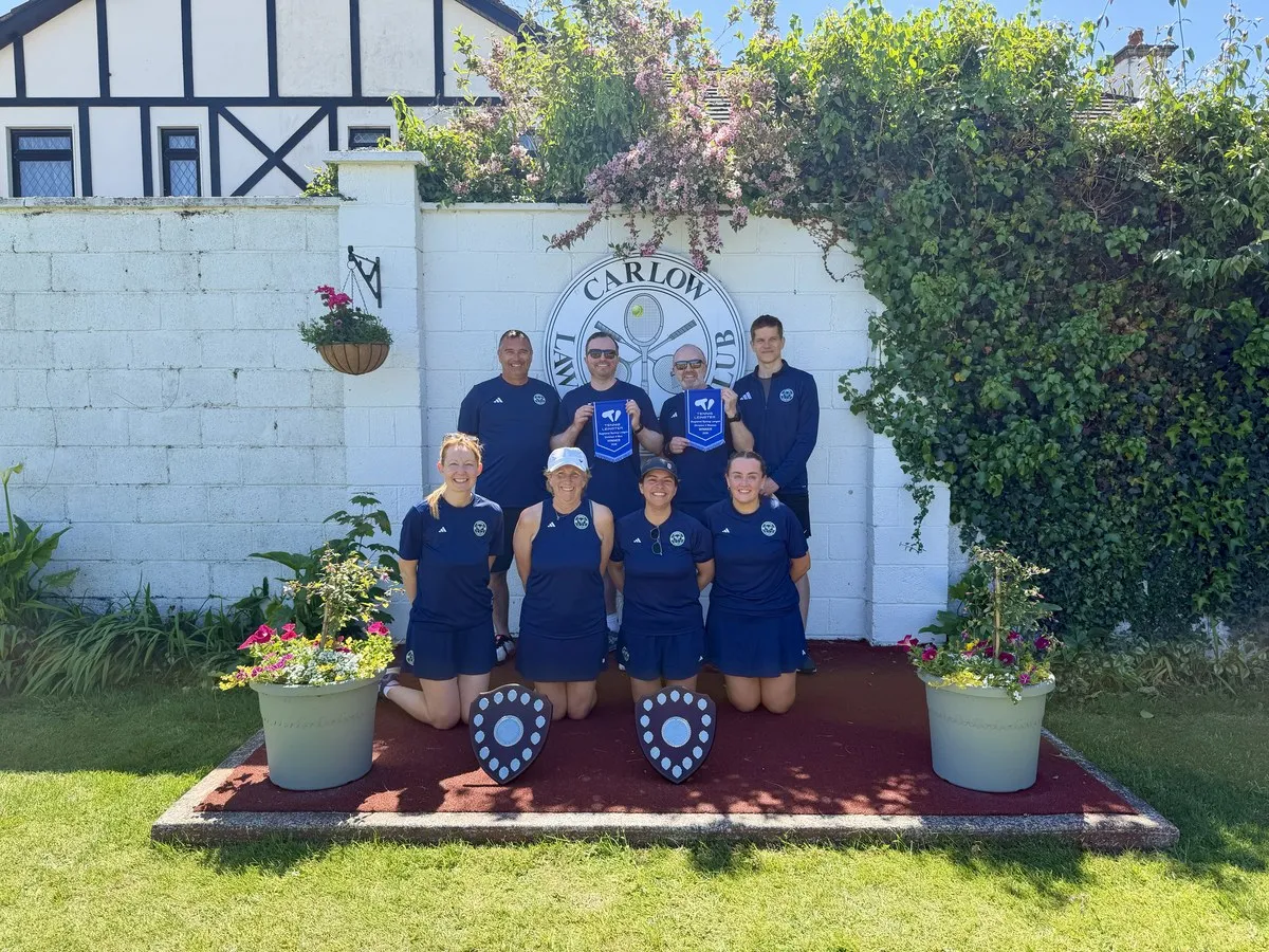 Romina and her Leinster League tennis team holding championship shields at Carlow LTC