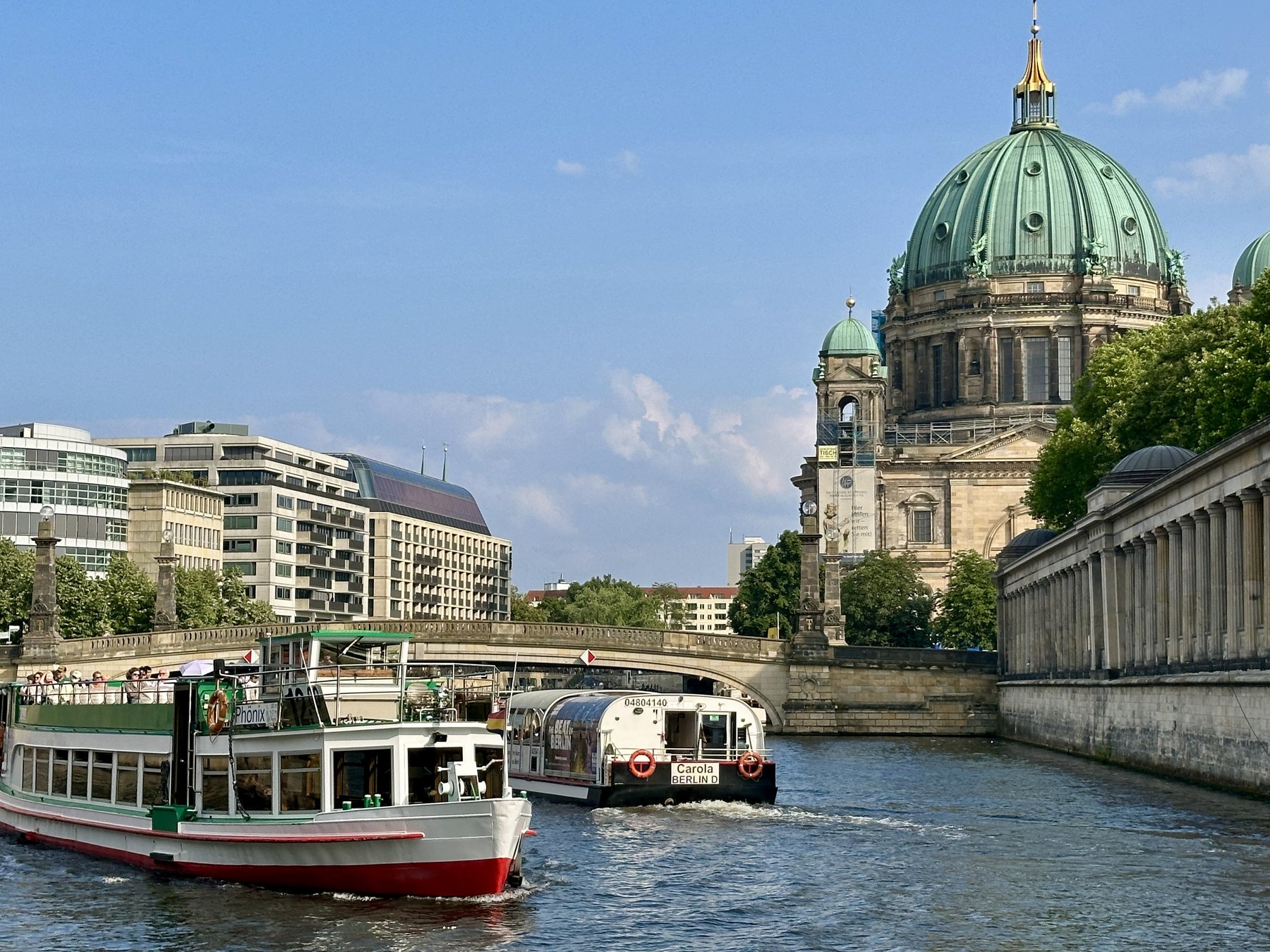 Berliner Dom and tourist boats on the Spree river on a sunny day