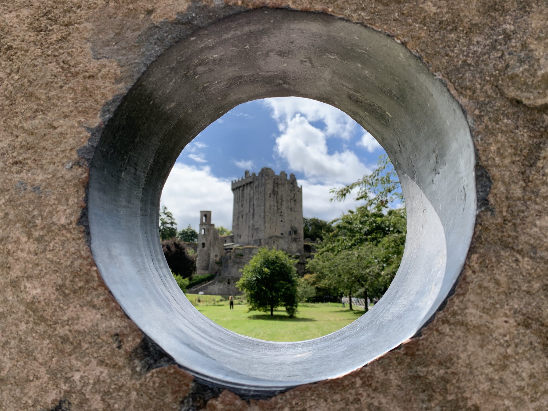 Blarney Castle framed through a circular stone opening