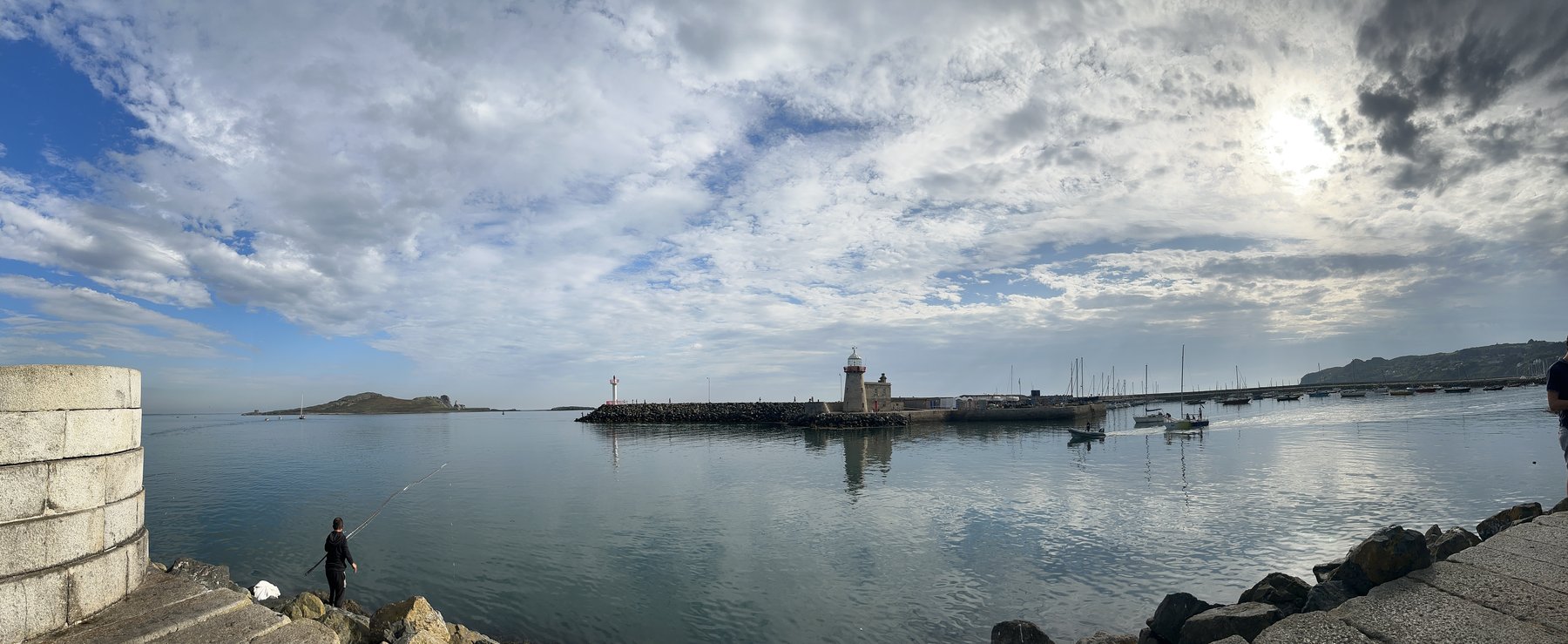 Panoramic view of Howth Marina on a calm day, pier and lighthouse stretching into Dublin Bay