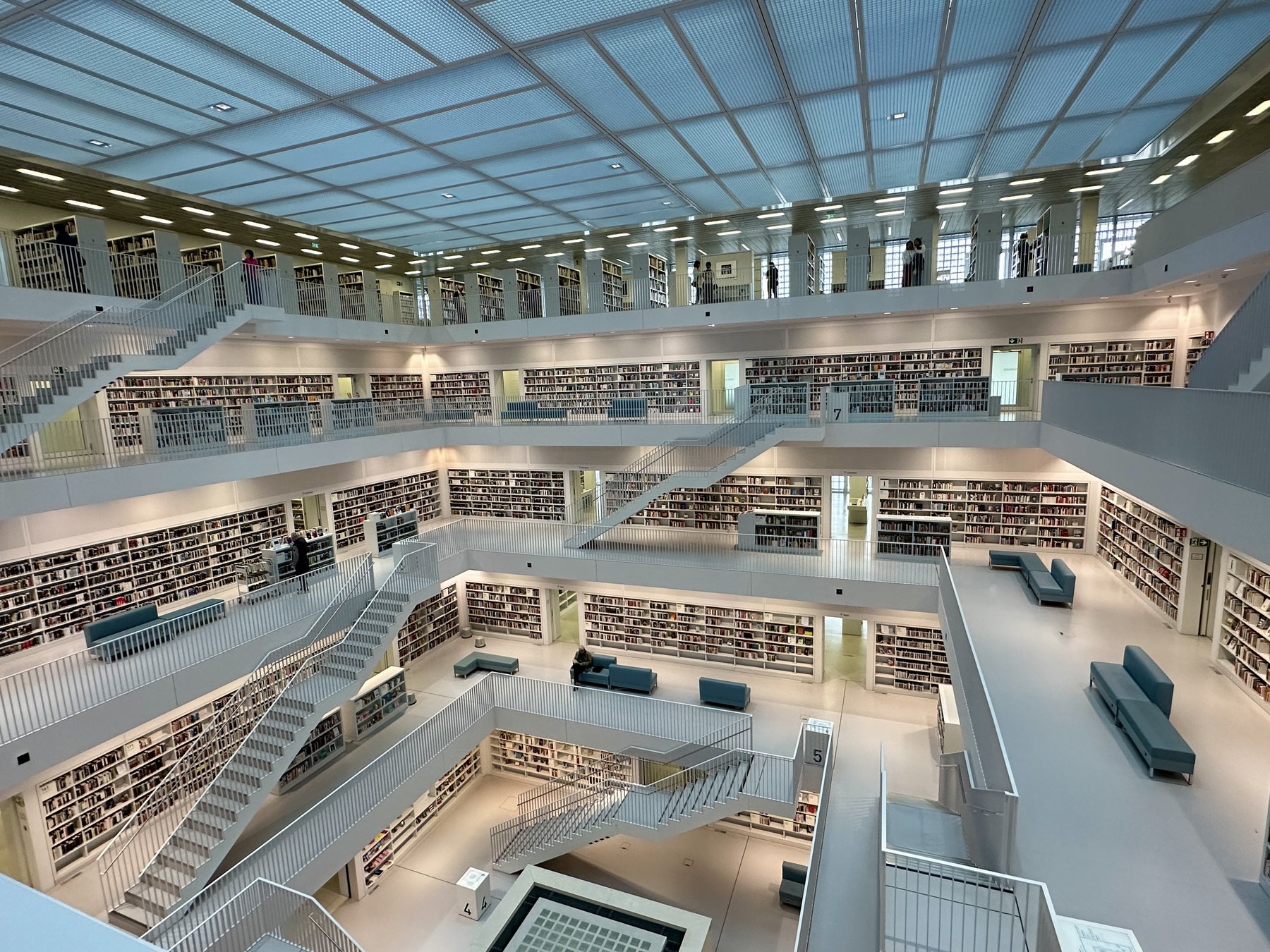 Stadtbibliothek Stuttgart interior — white minimalist architecture with stacked floors of bookshelves